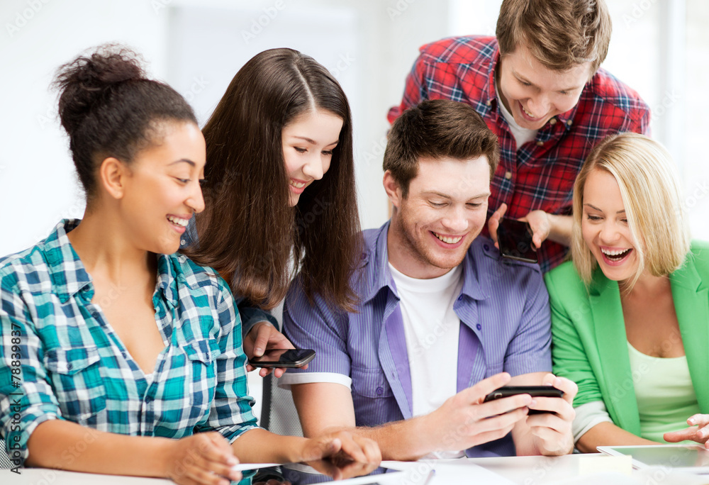 students looking at smartphone at school students looking at smartphone at school