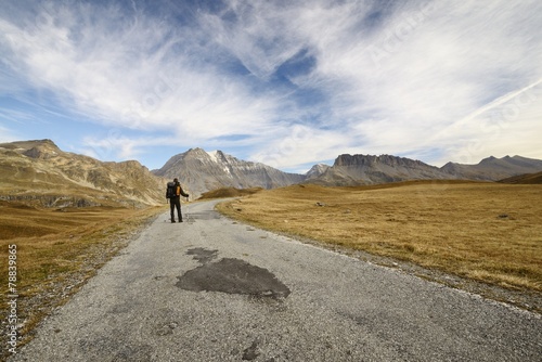 a hiker walking on a road in the Vanoise national park 