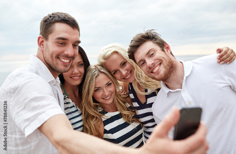 happy friends on beach and taking selfie happy friends on beach and taking selfie