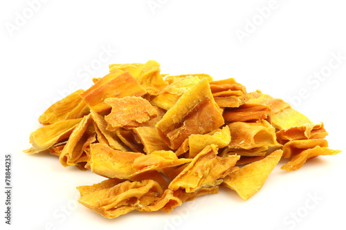 colorful pieces of dried mango fruit on a white background
