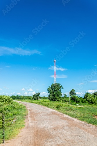 Red and white tower of communications  on clear sky.