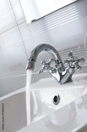 Steel faucet in a bathroom