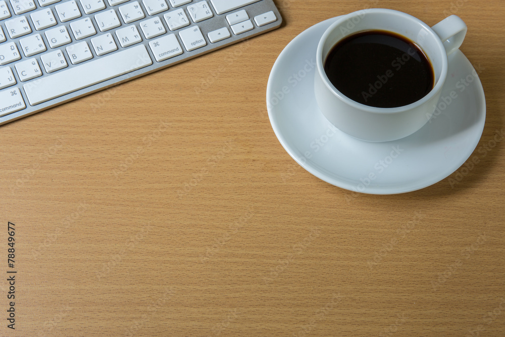 Cup of fragrant coffee on a morning paper and keyboard Cup of fragrant coffee on a morning paper and keyboard