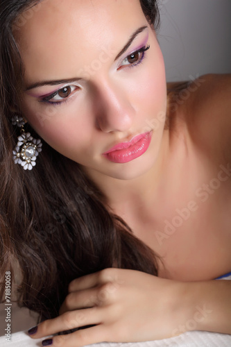 Portrait of young beautiful woman with fashion makeup