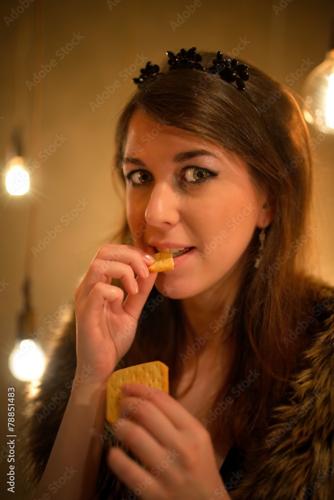 The beautiful girl ridiculously eats cookies The beautiful girl ridiculously eats cookies