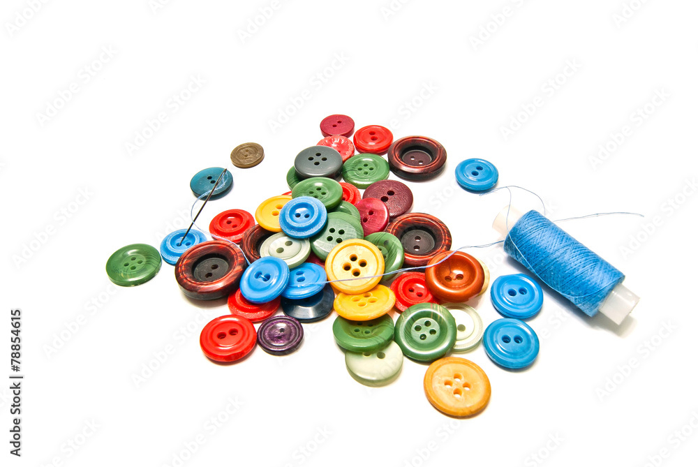 different buttons and spool of blue thread different buttons and spool of blue thread