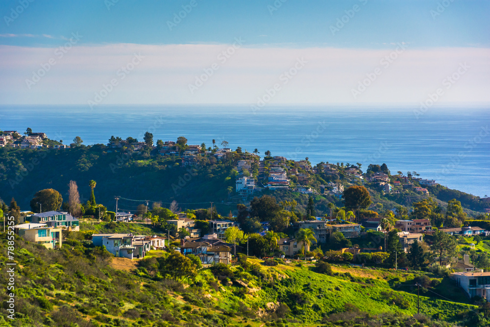View of green hills and houses overlooking the Pacific Ocean, in
