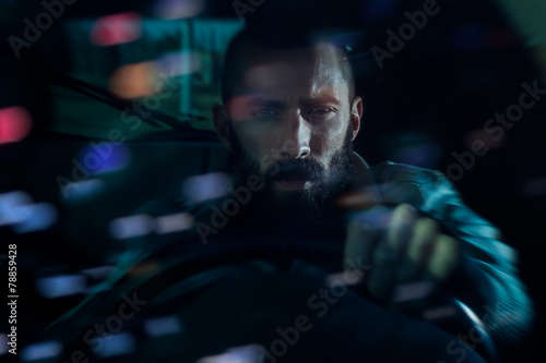 Man driving around the city at night