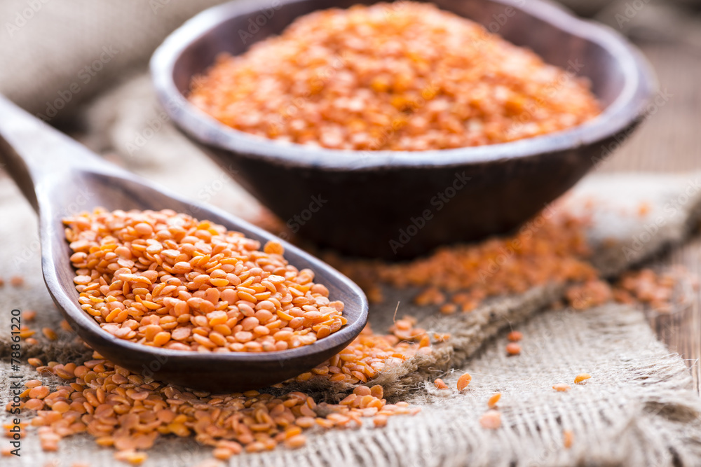 Red Lentils on a wooden spoon - obrazy, fototapety, plakaty 