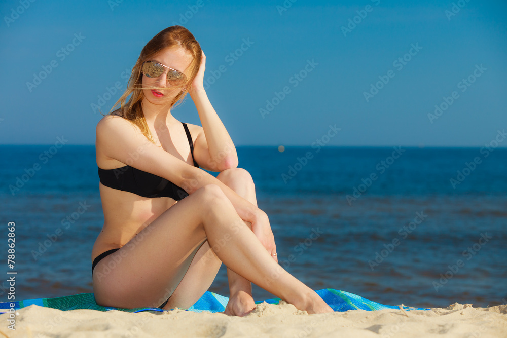 Fototapeta premium Summer vacation Girl in bikini sunbathing on beach