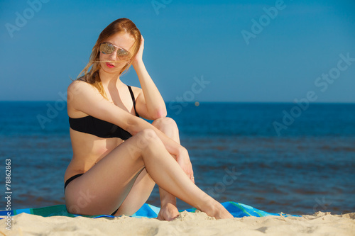 Summer vacation Girl in bikini sunbathing on beach