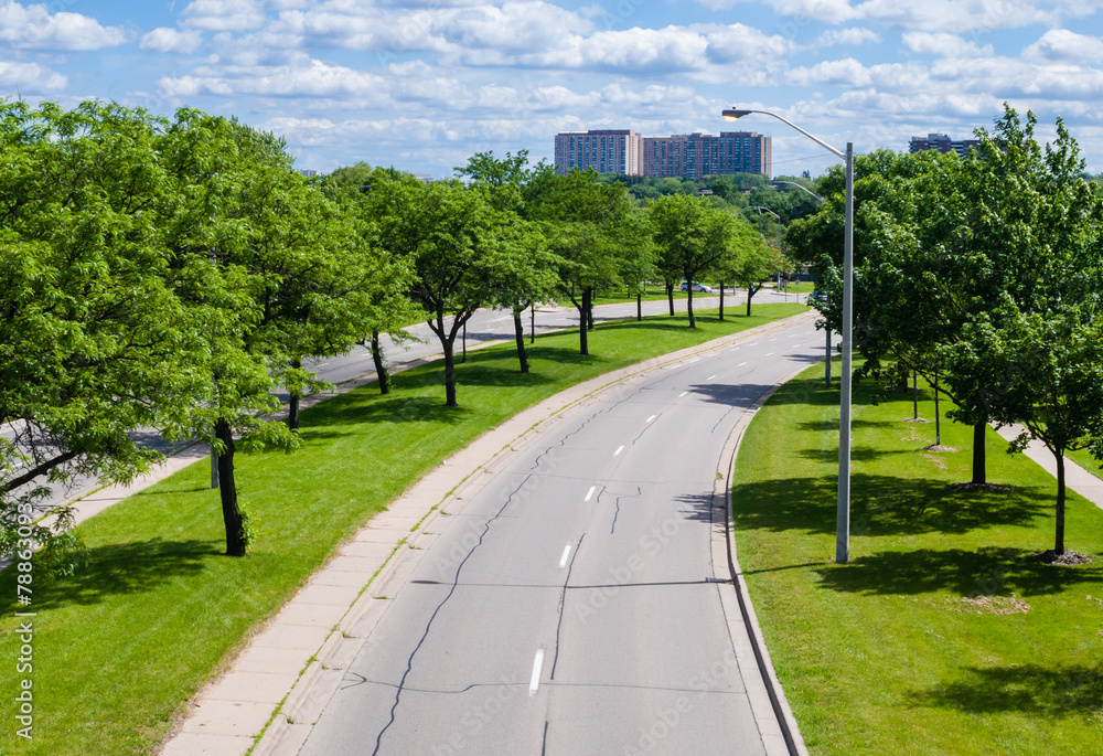 Empty street curving right with trees