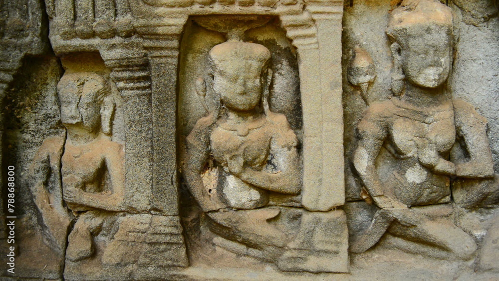Zoom out- Stone Carving of Religious Icons on Temple Wall - Angkor Wat, Cambodia Zoom out- Stone Carving of Religious Icons on Temple Wall - Angkor Wat, Cambodia