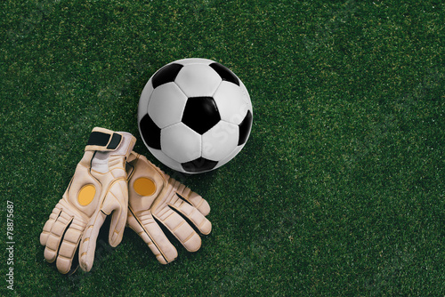 Soccer ball and goalkeeper gloves photo