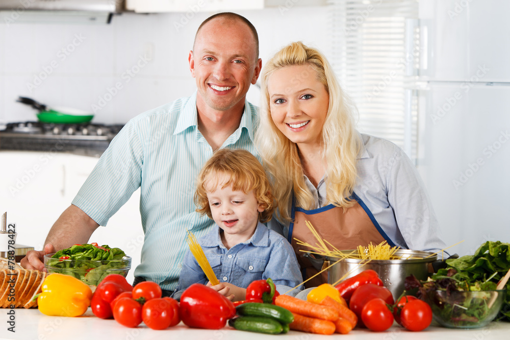 Happy family preparing a healthy dinner at home.
