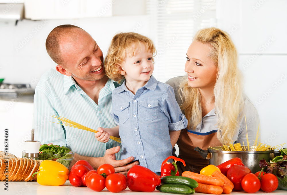 Happy family preparing a healthy dinner at home. Happy family preparing a healthy dinner at home.
