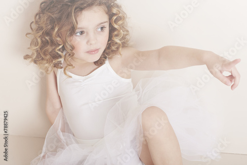 Young girl pointing in studio
