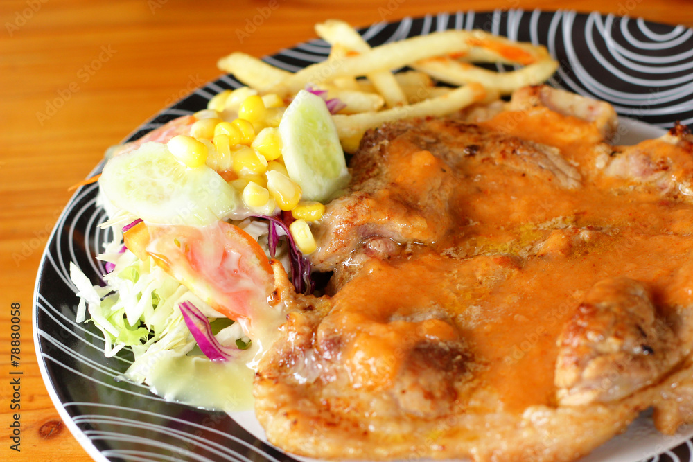 Steaks, french fries with vegetables salad on a plate. Steaks, french fries with vegetables salad on a plate.