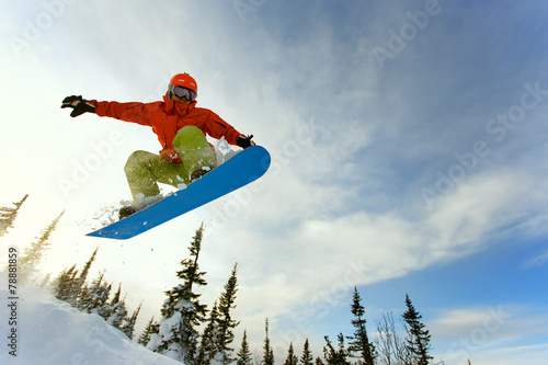 Snowboarder jumping photo