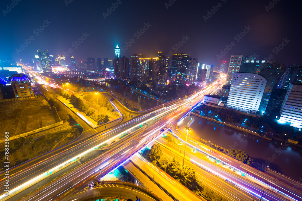 traffic light trails on overpass and cityscape at night traffic light trails on overpass and cityscape at night
