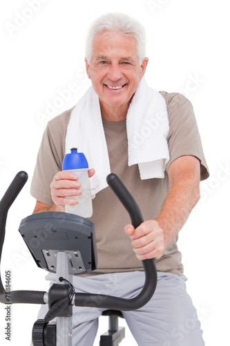 Senior man on exercise bike