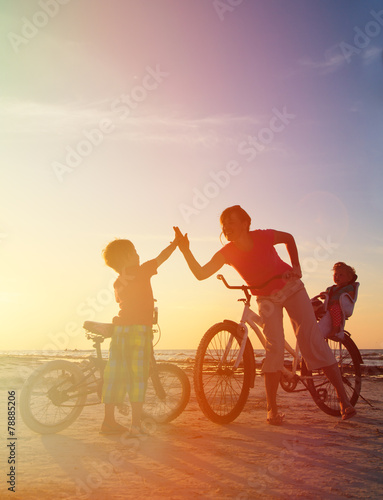 Biker family silhouette at sunset