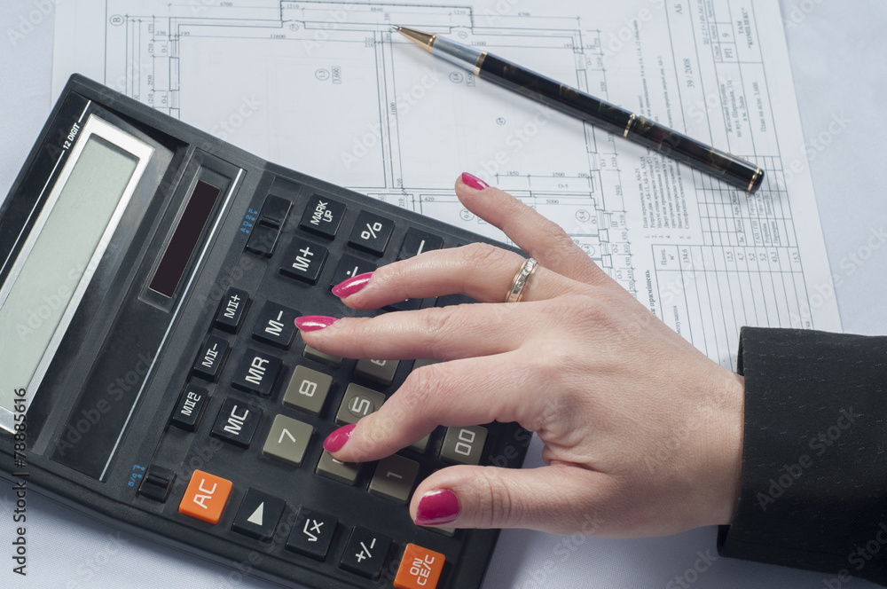 Business woman counting with a calculator Business woman counting with a calculator
