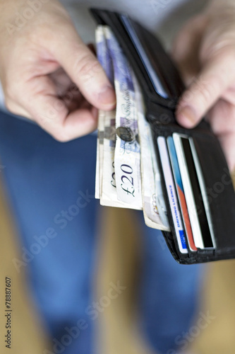 Man with cash inside wallet