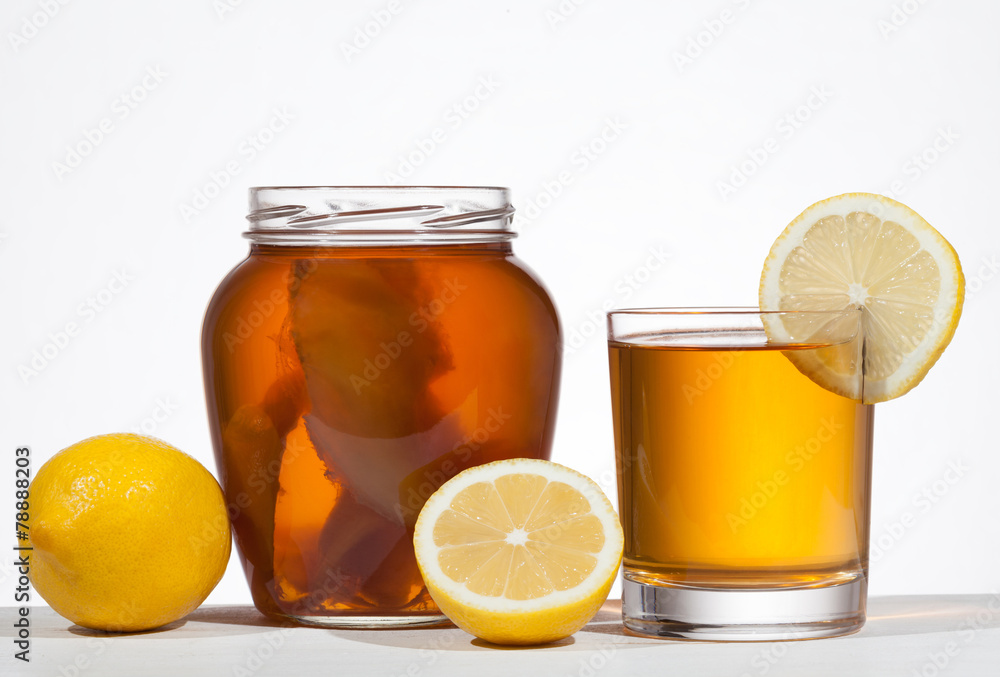 Kombucha super food pro biotic beverage in glass with lemon on w Kombucha super food pro biotic beverage in glass with lemon on w