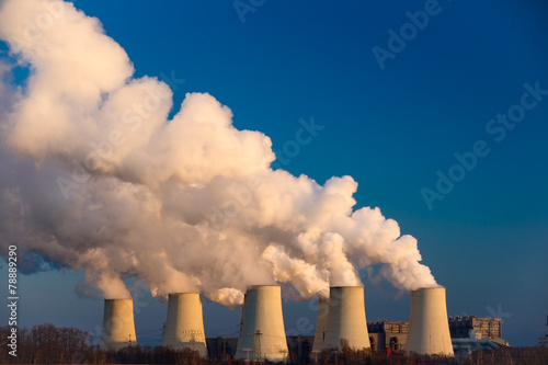 Smoking pipes of thermal power plant on sunset