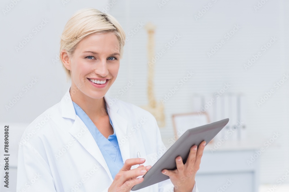 Confident female doctor using digital tablet Confident female doctor using digital tablet