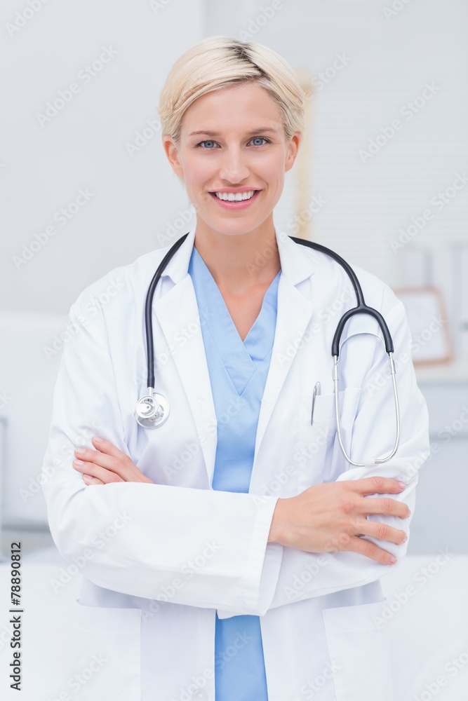 Female doctor with arms crossed standing in clinic Female doctor with arms crossed standing in clinic