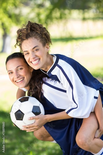 Pretty football players smiling at camera