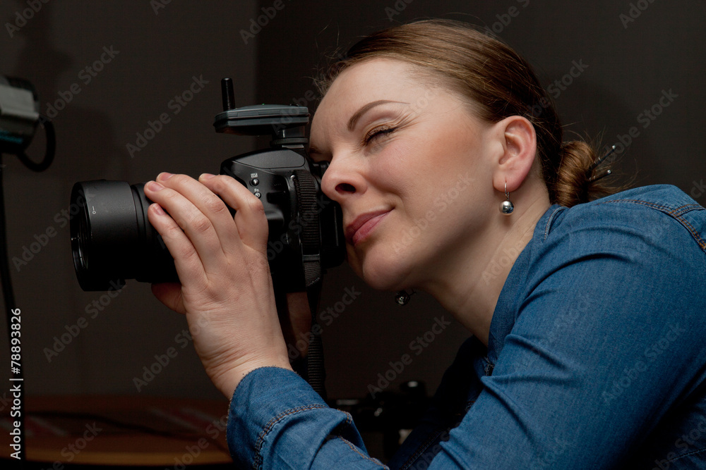 Photographer woman holding camera and taking pictures Photographer woman holding camera and taking pictures