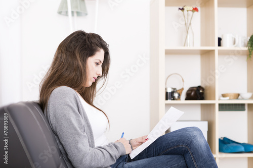 Beautiful young woman working and studying at home