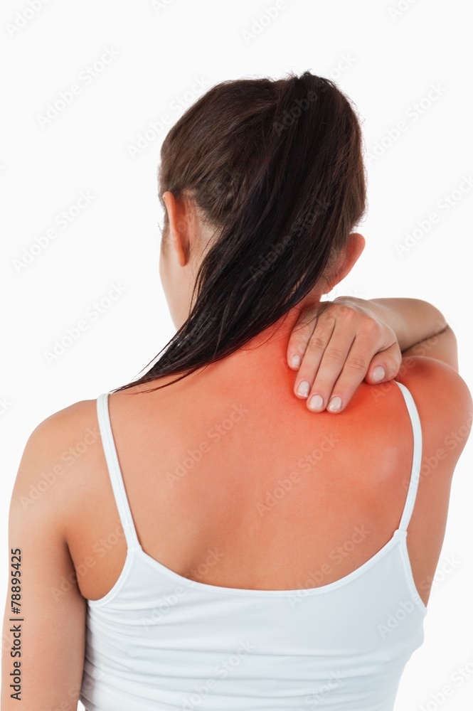Back view of female with pain in her neck Back view of female with pain in her neck