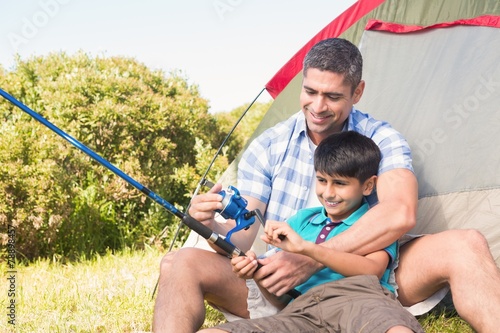 Father and son beside tent