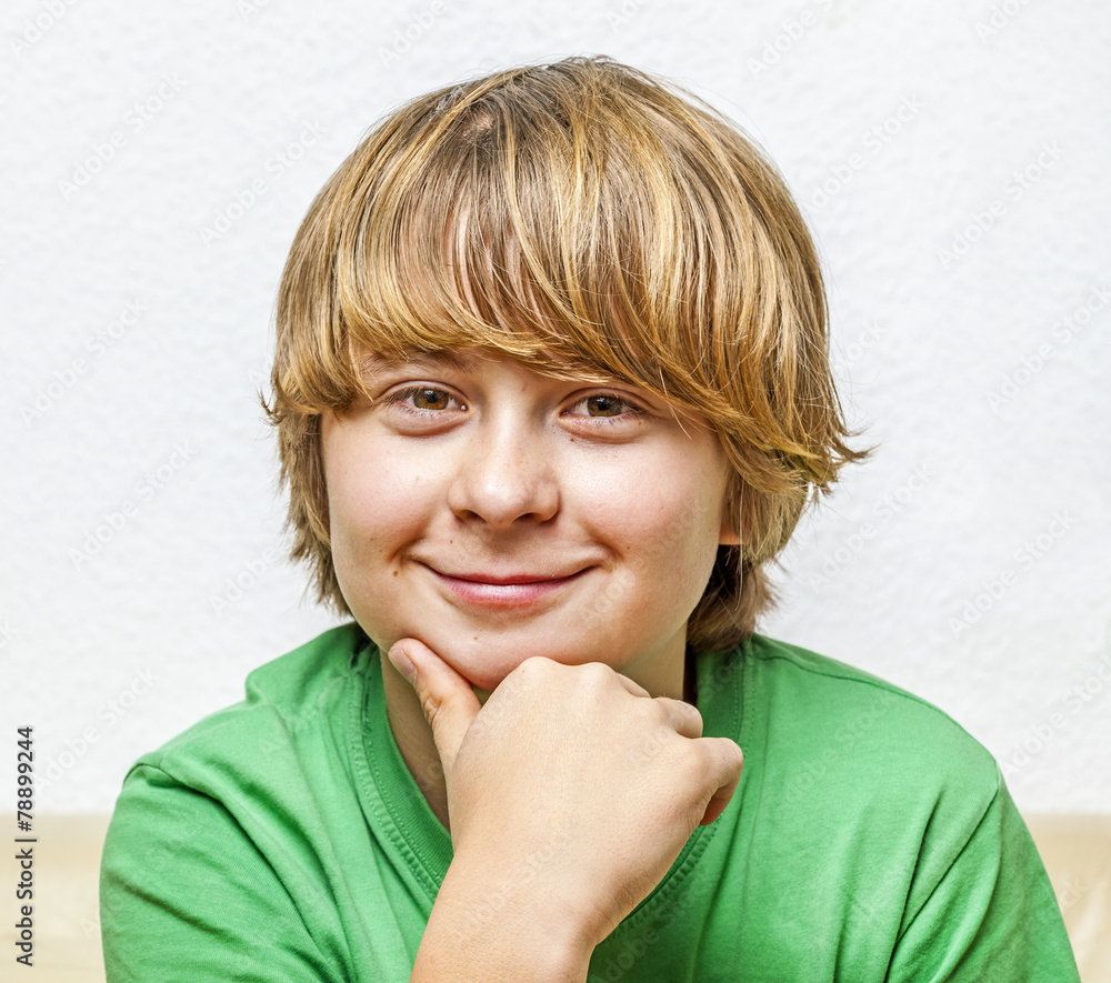 smiling boy sitting on a sofa smiling boy sitting on a sofa