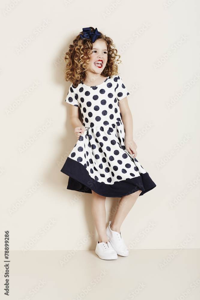 Girl laughing in spotty dress Girl laughing in spotty dress
