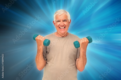 Happy senior man exercising with dumbbells