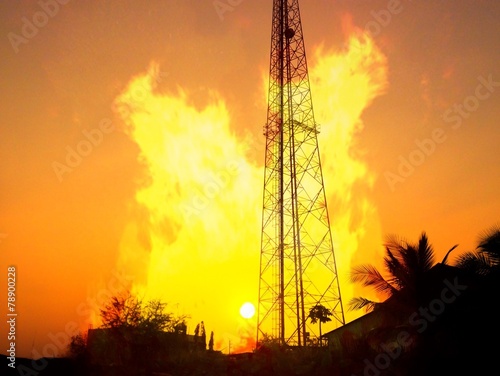 reception antenna with  orange sky and fire