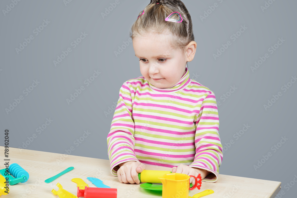 Girl playing with plastic tableware
