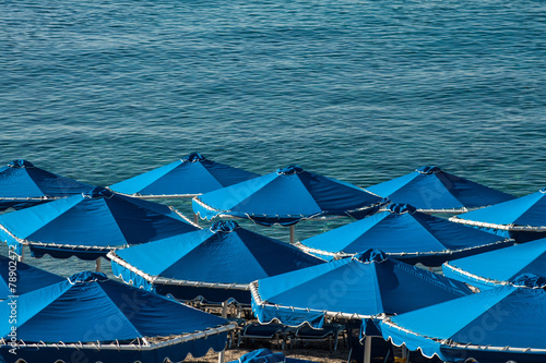 blue umbrella on the beach near the sea