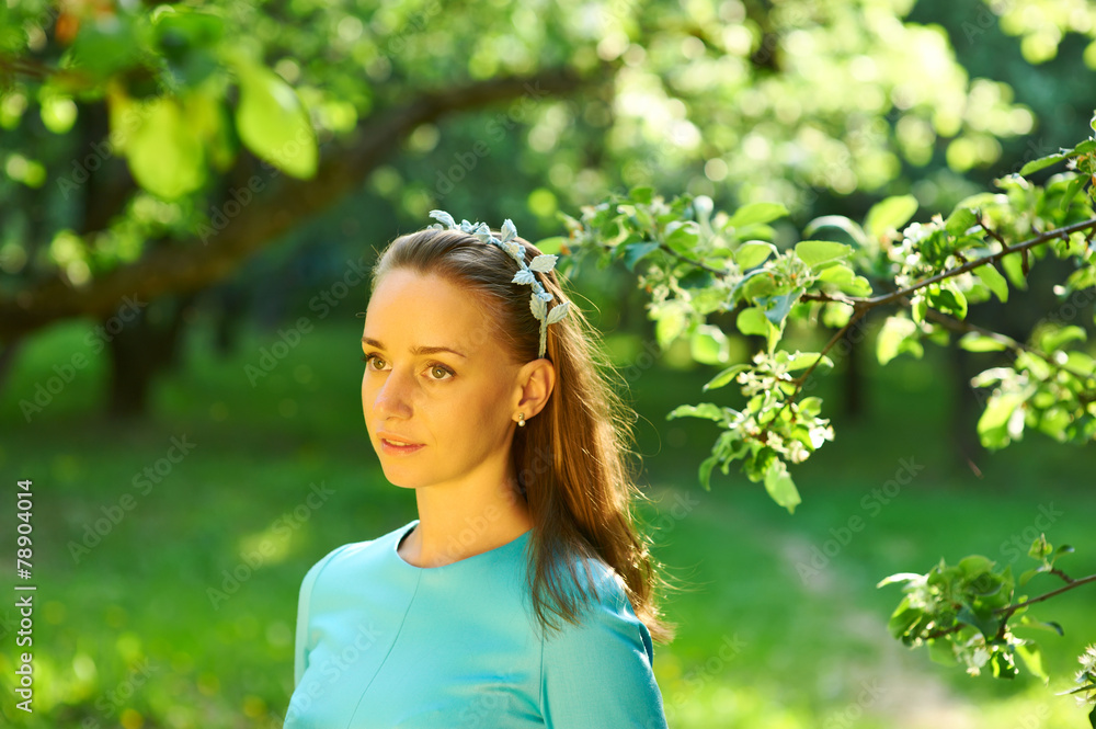 Woman in dress among apple blossoms Woman in dress among apple blossoms