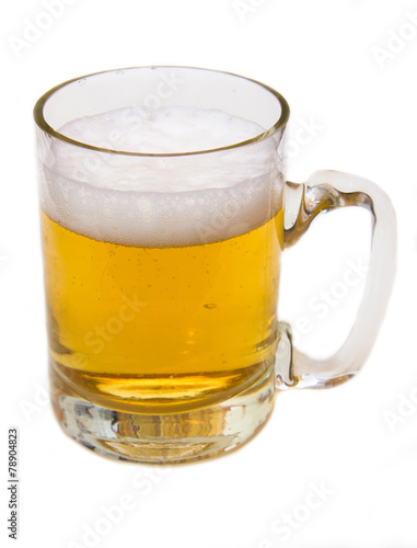 Mug of beer with froth over white background