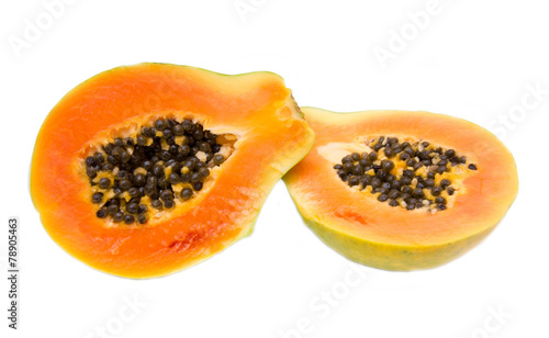 Fresh papaya cut in half on white background