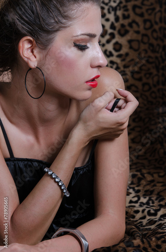 Sexy woman in studio, animal print fabric as background