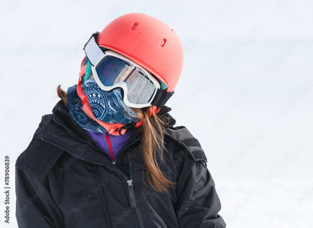 Girl skier portrait wrapped up warm in skiing gear with helmet a Girl skier portrait wrapped up warm in skiing gear with helmet a