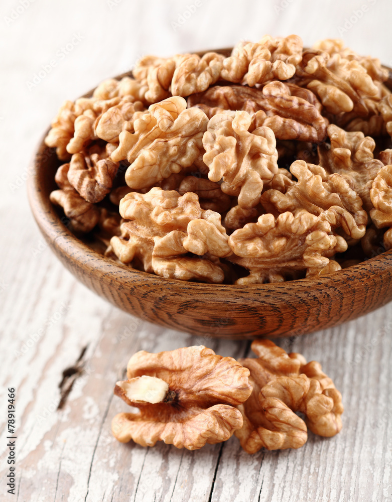 Walnuts in a wooden plate Walnuts in a wooden plate
