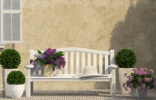 White bench, green and lilac flowers